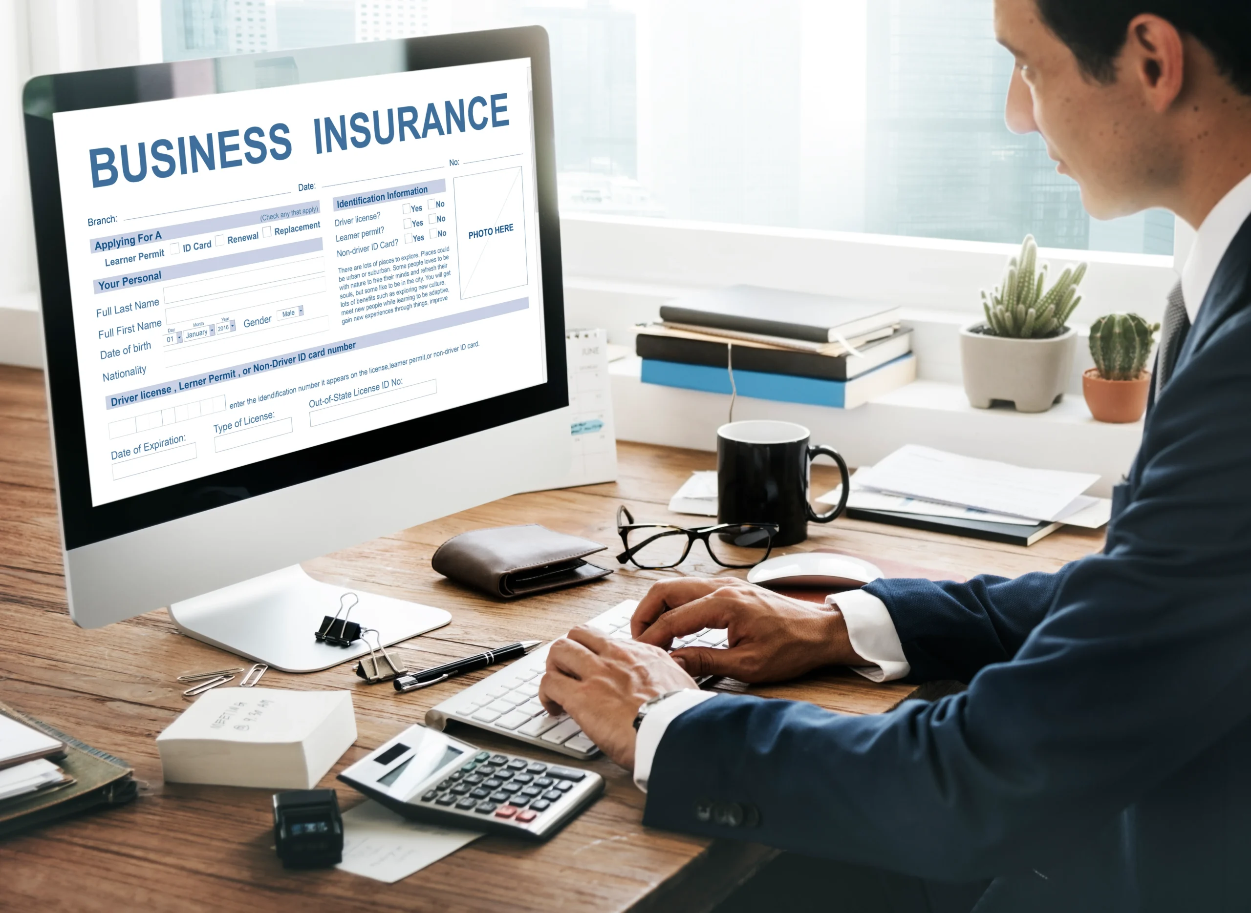 A professional business owner reviewing insurance documents at a desk, symbolizing the importance of business insurance for financial protection and peace of mind